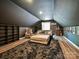 Finished bonus room featuring dark walls, plush rug, comfortable seating, and a shelving unit at 2437 Woodleigh Dr, Gastonia, NC 28056