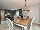Dining area adjacent to the kitchen, featuring a chandelier and a window view at 2437 Woodleigh Dr, Gastonia, NC 28056