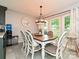 Dining area features a wood table, a chandelier, and a window view at 2437 Woodleigh Dr, Gastonia, NC 28056