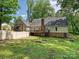 Exterior view of the home from the backyard showcasing its deck and outdoor living spaces at 2437 Woodleigh Dr, Gastonia, NC 28056