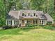Charming home with a brick facade, dormer windows, and a well-manicured lawn at 2437 Woodleigh Dr, Gastonia, NC 28056