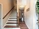 Hallway with wooden floors and a staircase with a wooden banister at 2437 Woodleigh Dr, Gastonia, NC 28056