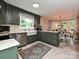 Well-lit kitchen with green cabinets, stainless steel appliances, and a farm sink at 2437 Woodleigh Dr, Gastonia, NC 28056