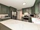 Updated kitchen featuring stainless steel appliances and a marble countertop island at 2437 Woodleigh Dr, Gastonia, NC 28056