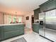 Spacious kitchen with stainless steel refrigerator and green cabinets at 2437 Woodleigh Dr, Gastonia, NC 28056