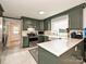Modern kitchen with stainless steel appliances, green cabinets, and marble countertops at 2437 Woodleigh Dr, Gastonia, NC 28056