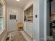 Functional laundry room includes a washer, dryer, and folding table with cabinets above at 2437 Woodleigh Dr, Gastonia, NC 28056