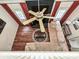 Bright living room with wood floors, sectional couch, and black brick fireplace at 2437 Woodleigh Dr, Gastonia, NC 28056