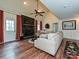 Inviting living room boasts a fireplace with black brick surround and red curtains at 2437 Woodleigh Dr, Gastonia, NC 28056