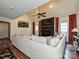 Cozy living room with a large sectional couch, a brick fireplace, and hardwood floors at 2437 Woodleigh Dr, Gastonia, NC 28056
