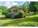 A brick home on a lush green lawn featuring mature trees and landscaping at 2871 Loviee Rd, Lincolnton, NC 28092