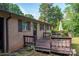 Wooden deck featuring an umbrella and seating attached to a brick home with green grass at 2871 Loviee Rd, Lincolnton, NC 28092