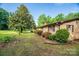 Brick home with manicured shrubs and an expansive lawn at 2871 Loviee Rd, Lincolnton, NC 28092