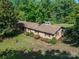 Aerial view of a brick single-story home with a well-maintained lawn and mature trees at 2871 Loviee Rd, Lincolnton, NC 28092