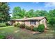 Charming brick home featuring well-maintained landscaping and a lush green lawn at 2871 Loviee Rd, Lincolnton, NC 28092