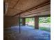 Open garage with concrete floor leading to outdoor deck and greenery at 2871 Loviee Rd, Lincolnton, NC 28092
