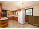 View of the kitchen featuring a refrigerator, wood cabinetry, stove, and an oven at 2871 Loviee Rd, Lincolnton, NC 28092