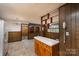 Kitchen bar area features wooden cabinetry and shelving connecting to the eat-in kitchen space at 2871 Loviee Rd, Lincolnton, NC 28092