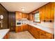 Eat-in kitchen features wooden cabinetry, ample counter space, and natural lighting at 2871 Loviee Rd, Lincolnton, NC 28092