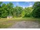 Rustic outbuilding surrounded by green trees with a well-manicured lawn at 2871 Loviee Rd, Lincolnton, NC 28092
