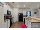 Beautiful kitchen with white cabinets, granite countertops, and black appliances at 2922 Patishall Ln, Charlotte, NC 28214