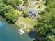 An aerial view of the home with a well-maintained backyard, landscaping, and a private dock on the lake at 3005 Vernell Ln, Shelby, NC 28150