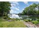 The backyard features lush green grass, landscaping, and a covered dock with panoramic lake views at 3005 Vernell Ln, Shelby, NC 28150