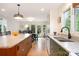 Bright kitchen featuring a large island with seating and custom cabinets at 3005 Vernell Ln, Shelby, NC 28150