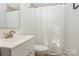 Bright bathroom with a white vanity, a stylish sink and a framed mirror over the toilet and bathtub at 3141 Mathis Dr, Charlotte, NC 28208