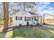 Charming white brick home featuring a cozy front porch and landscaped yard at 3141 Mathis Dr, Charlotte, NC 28208