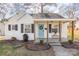 Charming white brick home featuring a cozy front porch and a vibrant blue front door with tasteful wreath at 3141 Mathis Dr, Charlotte, NC 28208
