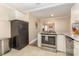 Well-equipped kitchen with stainless steel oven and an open design leading to the living room at 3141 Mathis Dr, Charlotte, NC 28208