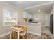 Eat-in kitchen featuring white cabinets, new appliances, and modern countertops at 3141 Mathis Dr, Charlotte, NC 28208