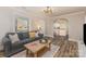Inviting living room with hardwood floors and open view to the updated kitchen at 3141 Mathis Dr, Charlotte, NC 28208