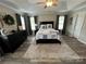 Bright bedroom featuring a tray ceiling, ceiling fan, and wood-look flooring at 334 River Birch Cir, Mooresville, NC 28115