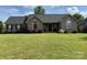 Charming single-story brick home with a well-manicured lawn and mature landscaping at 334 River Birch Cir, Mooresville, NC 28115