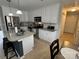 Modern kitchen featuring stainless steel appliances, granite countertops, and a central island at 334 River Birch Cir, Mooresville, NC 28115