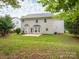 Large backyard featuring a well-maintained lawn, mature trees, and a patio area perfect for outdoor entertaining at 3626 Cole Mill Rd, Charlotte, NC 28270