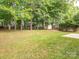 Spacious backyard featuring mature trees, well maintained lawn, and a storage shed at 3626 Cole Mill Rd, Charlotte, NC 28270