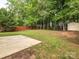 Expansive backyard featuring a patio, lush lawn and mature trees providing privacy at 3626 Cole Mill Rd, Charlotte, NC 28270