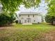 Spacious backyard with lush green grass, mature trees, and a patio area at 3626 Cole Mill Rd, Charlotte, NC 28270
