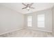 Neutral bedroom with carpet, two windows and a ceiling fan at 3626 Cole Mill Rd, Charlotte, NC 28270