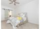 Cozy bedroom with a large bed, barn door to the bathroom and a ceiling fan at 3626 Cole Mill Rd, Charlotte, NC 28270