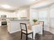 Cozy dining area featuring hardwood floors, modern table setting and a bay window at 3626 Cole Mill Rd, Charlotte, NC 28270