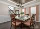 Formal dining room featuring decorative tray ceiling, chandelier, and large table setting at 3626 Cole Mill Rd, Charlotte, NC 28270
