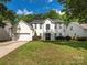 Charming two-story home with a well-maintained lawn and mature trees at 3626 Cole Mill Rd, Charlotte, NC 28270