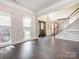 Inviting foyer with dark hardwood flooring, staircase and decorative front door at 3626 Cole Mill Rd, Charlotte, NC 28270