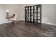 Cozy home office featuring a desk, chair, and large shelving unit on dark hardwood flooring at 3626 Cole Mill Rd, Charlotte, NC 28270