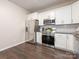 Modern kitchen featuring stainless steel appliances, white cabinets, and a subway tile backsplash at 3626 Cole Mill Rd, Charlotte, NC 28270