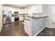 Eat-in kitchen featuring white cabinets, granite countertops, stainless steel appliances, and hardwood flooring at 3626 Cole Mill Rd, Charlotte, NC 28270